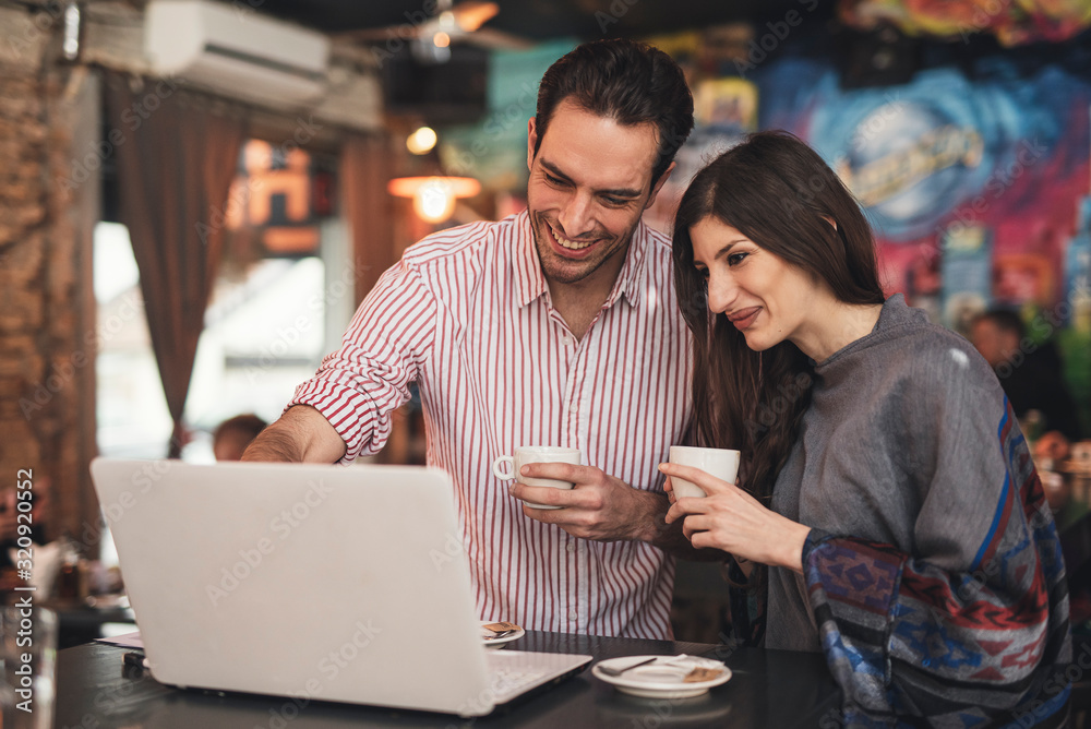 Young couple have fun and enjoying in cafe Young couple have fun and enjoying in cafe