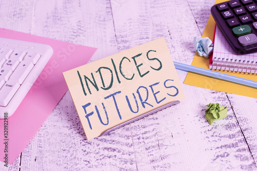 Conceptual hand writing showing Indices Futures. Concept meaning cashsettled futures contract on the value of a stock Notepaper on buffer wire in between keyboard and math sheets photo