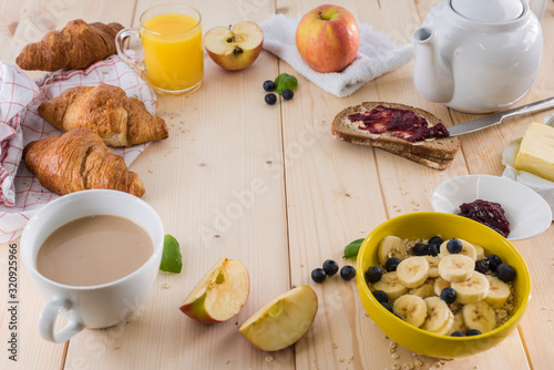 Good morning, great start to the day. Morning breakfast set with bowl of fruits of banana and berries. 