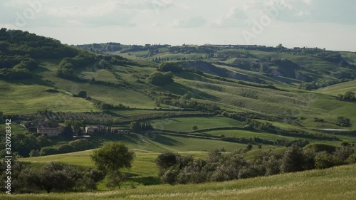 Panoramic view of scenic Tuscany landscape with rolling hills, valley, cypresses