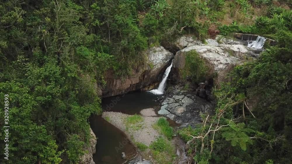 Las Garzas Waterfall, Adjuntas, Puerto Rico, Aerial View of Creek Water Falls in Pond Deep in Rainforest Las Garzas Waterfall, Adjuntas, Puerto Rico, Aerial View of Creek Water Falls in Pond Deep in Rainforest