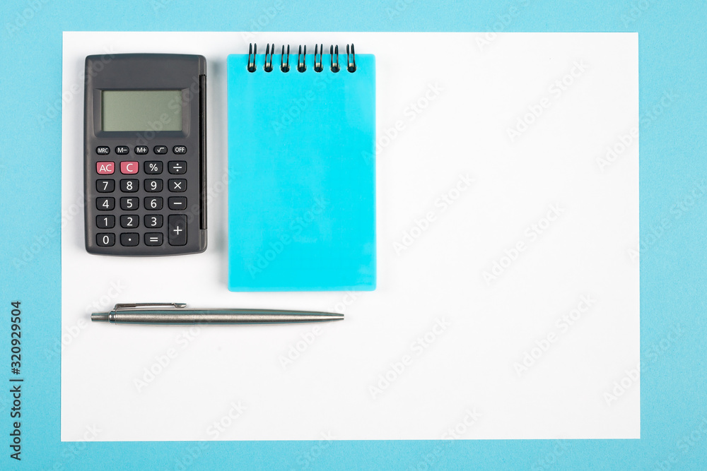 workspace top view. office Desk with office supplies and calculator. top view blue background workspace top view. office Desk with office supplies and calculator. top view blue background