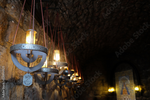 Montserrat, Spain - April 26: A photo of hang candles at the monastery in the province of Catalonia on April 26, 2017 in Montserrat, Spain. photo