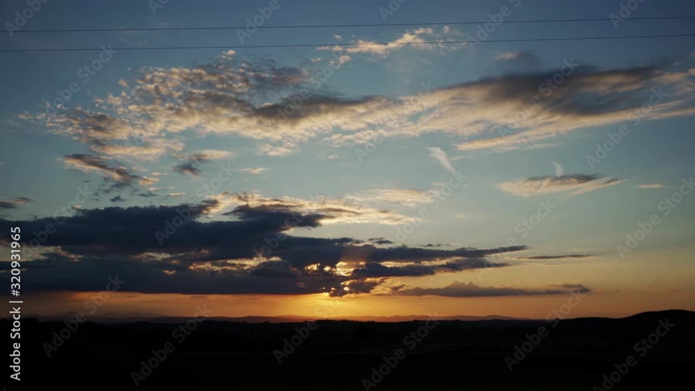 Amazing cloudy orange sunset on blue evening sky, background Amazing cloudy orange sunset on blue evening sky, background