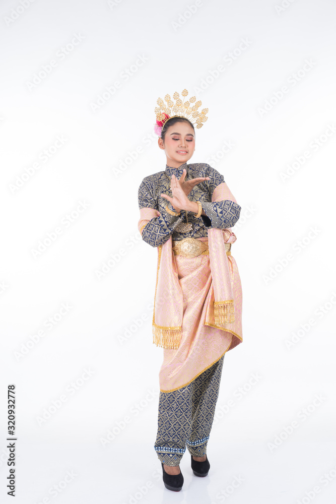 A beautiful Malaysian traditional female dancer performing the dance steps of a cultural dance routine called Tarian Inang in a traditional dance outfit. Full length isolated in white.