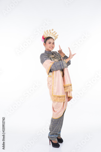 A beautiful Malaysian traditional female dancer performing the dance steps of a cultural dance routine called Tarian Inang in a traditional dance outfit. Full length isolated in white. photo