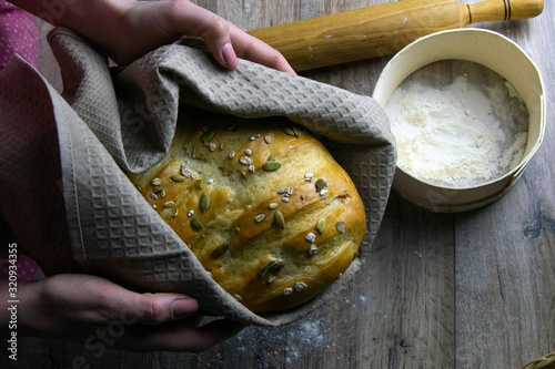 Closeup of fresh rustsic bread in a woman's hand photo