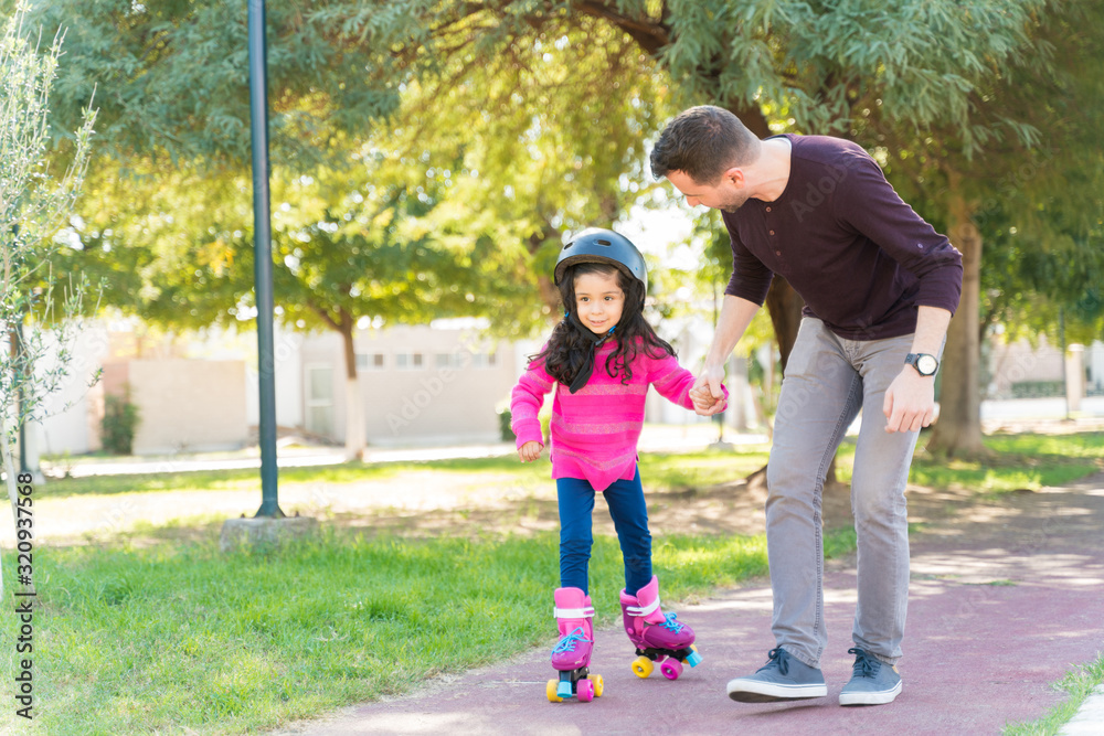 Girl Learning To Skate From Father Girl Learning To Skate From Father