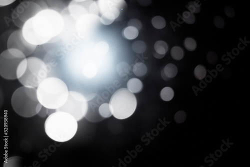 Abstract white bokeh on a black background 