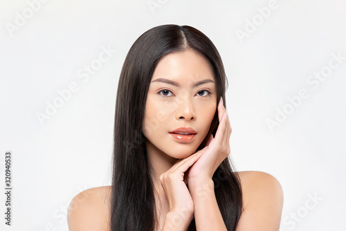 Beautiful Asian woman with fair skin doing hands on face pose