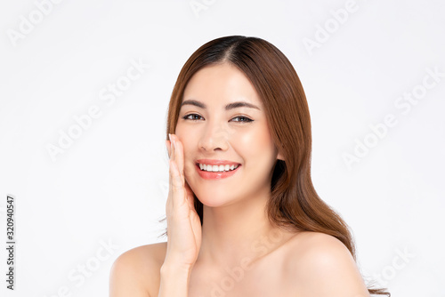Smiling Asian woman with fair skin hand touching her face