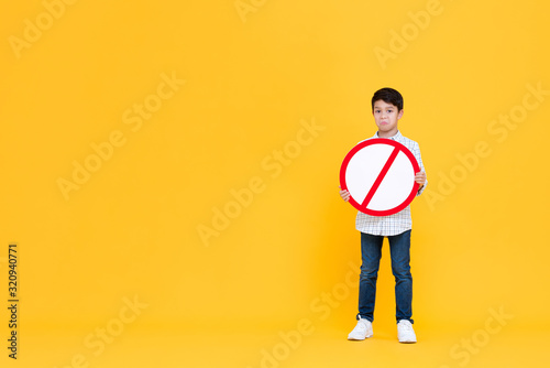 Sad young Asian boy holding red ban signage photo