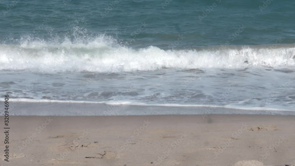 Ocean waves rolling onto a beach Ocean waves rolling onto a beach