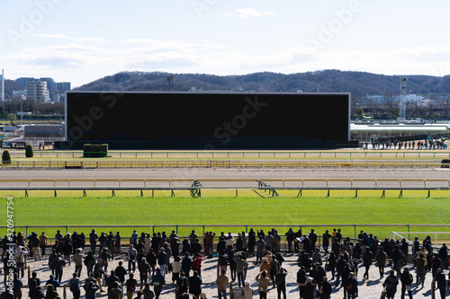 Crowd people watching monitors at racetrack