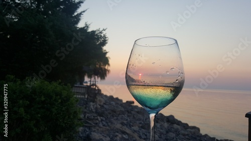 glass of white wine on a background of vineyard