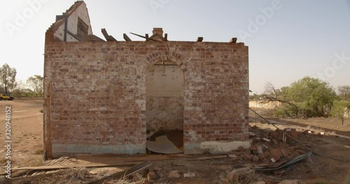 Old brick building left in ruins in a small deserted country town in Outback Australia photo