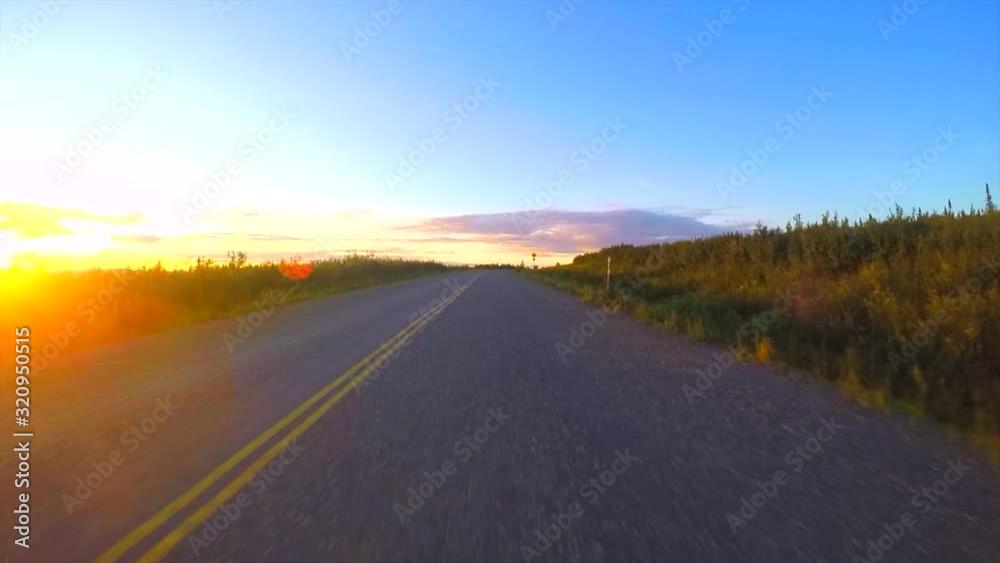 Driving during sunset on a beautiful Alaska road Driving during sunset on a beautiful Alaska road