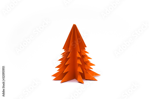 Orange origami christmas tree isolated on white background