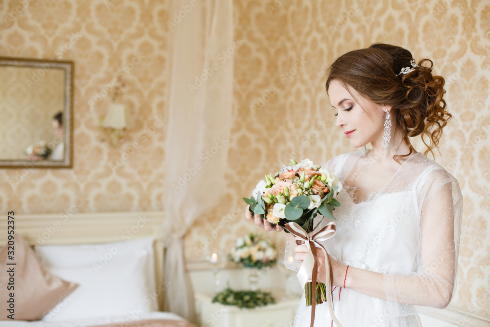 Pretty young Bride.Brown-haired woman with classic wedding hair-style. Boudoir morning of the bride. Taking a little candle in her hands Pretty young Bride.Brown-haired woman with classic wedding hair-style. Boudoir morning of the bride. Taking a little candle in her hands