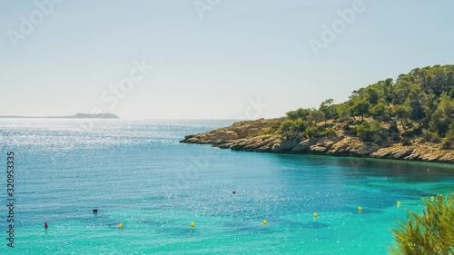 Ibiza Island, Spain - The Stunning Scenery Of Clear Blue Sea and ExoticTrees During A Sunny Day - Wide Shot photo