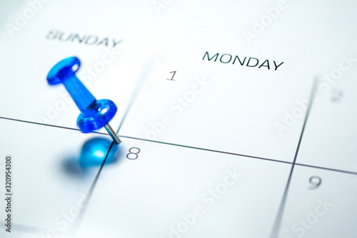 Blue push pin on 8th of Monday