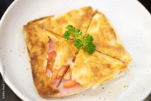 Puff pastry pies with ham and tomato. 