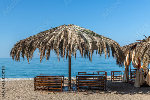 Beautiful arbor from palm leaves on the beach in Abkhazia