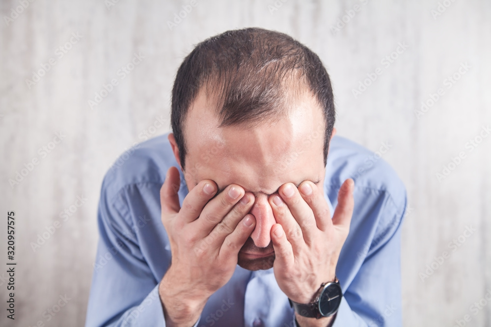 Tired man having vision problems. Tired man having vision problems.