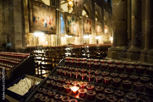 Lighting candles in a catholic temple . © suprunvitaly