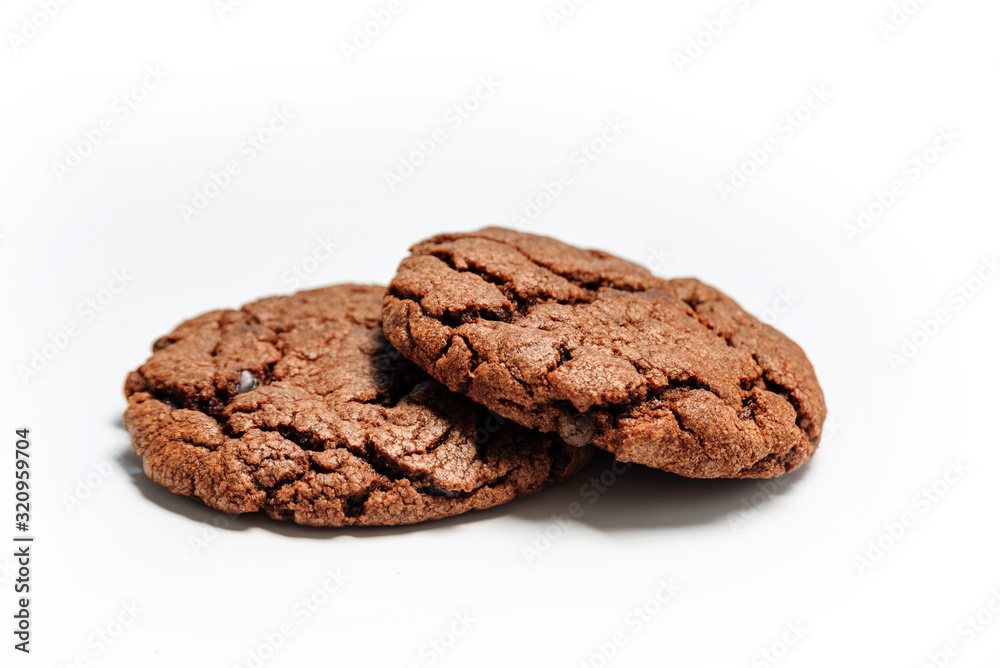 Two pieces of chocolate chip cookies on a white background. Two pieces of chocolate chip cookies on a white background.