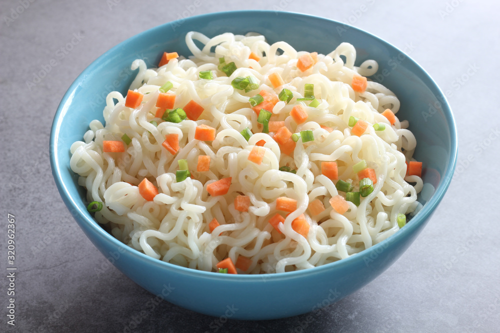 Instant noodles in a bowl isolated on dark background. Instant noodles in a bowl isolated on dark background.