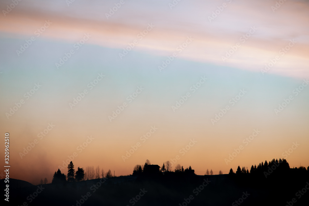 silhouette of village in mountains on sunrise