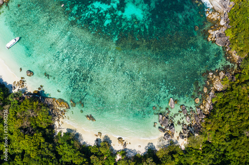 Aerial view drone shot ocean waves, Beautiful tropical beach and rocky coastline and beautiful forest. Nga Khin Nyo Gyee Island Myanmar. Tropical seas and islands in southern Myanmar