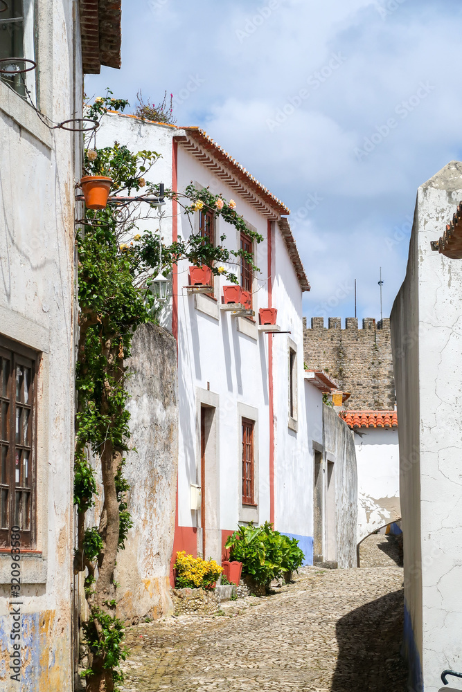 Old streets of a Portuguese town with white houses and tiled roofs