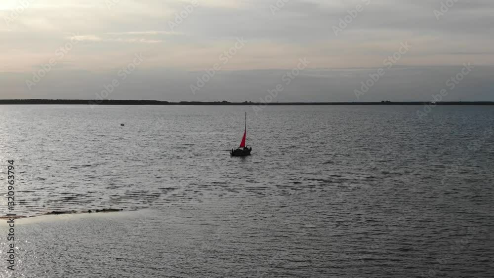 Aerial VIew of Silhouetted Sailboat Anchored on River During Early Evening Aerial VIew of Silhouetted Sailboat Anchored on River During Early Evening