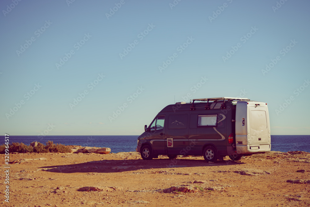Camper van on sea cliff, camping.