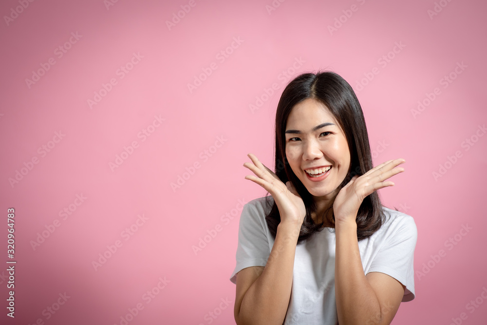 Portrait of a happy girl showing a gesture on a pink background Portrait of a happy girl showing a gesture on a pink background