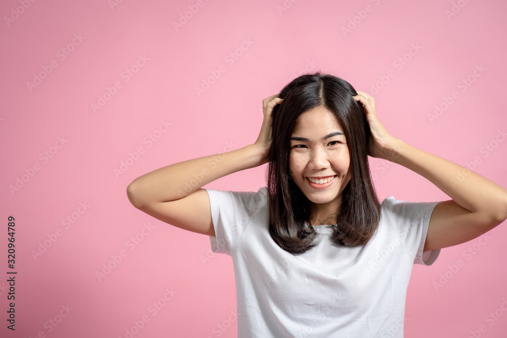 Portrait of a happy girl showing a gesture on a pink background Portrait of a happy girl showing a gesture on a pink background