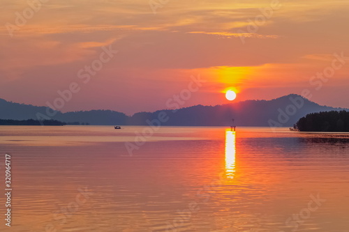 Sea view evening of sundown with red sun light and cloudy sky background  sunset at Kuraburi Pier  Phang Nga  southern of Thailand.