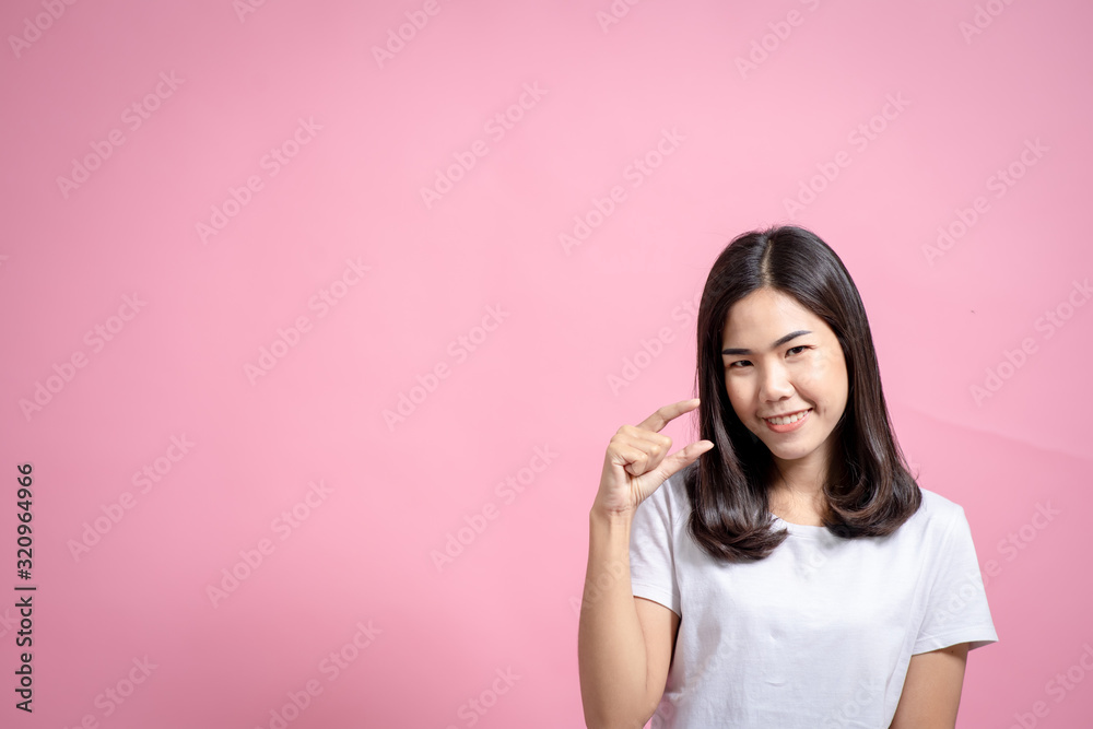 Portrait of a happy girl showing a gesture on a pink background Portrait of a happy girl showing a gesture on a pink background