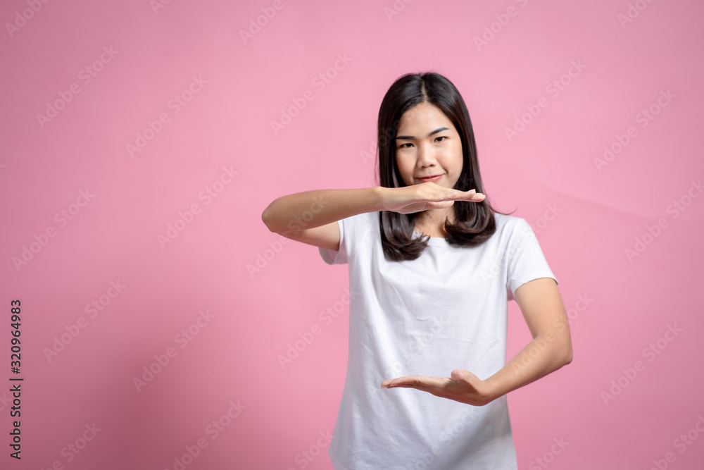 Portrait of a happy girl showing a gesture on a pink background Portrait of a happy girl showing a gesture on a pink background