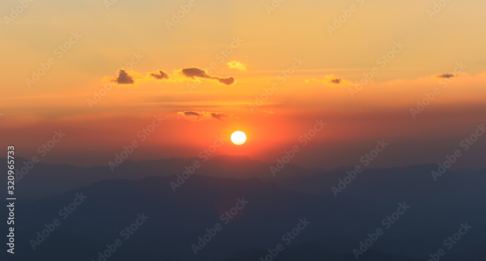 the sun sets behind the mountain peaks, captured at chiangmai, thailand the sun sets behind the mountain peaks, captured at chiangmai, thailand