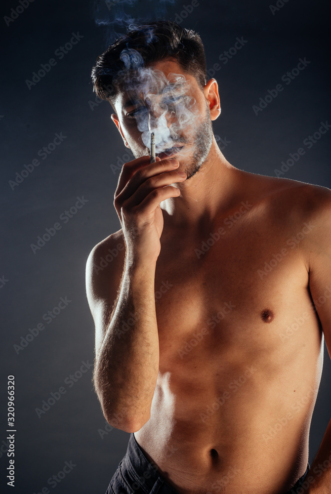 Fototapeta premium Young man smoking