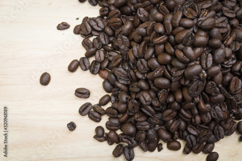 pile of coffee beans on bright wooden background