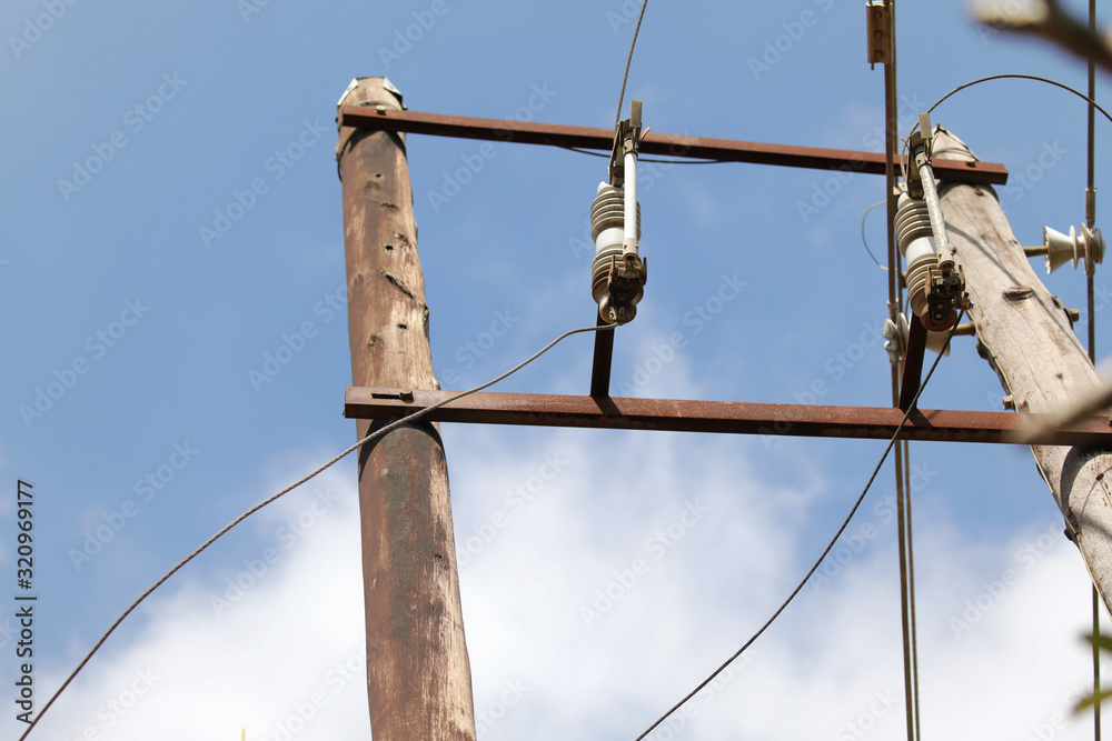 Electricity pole, fuses and cable against the sky Electricity pole, fuses and cable against the sky