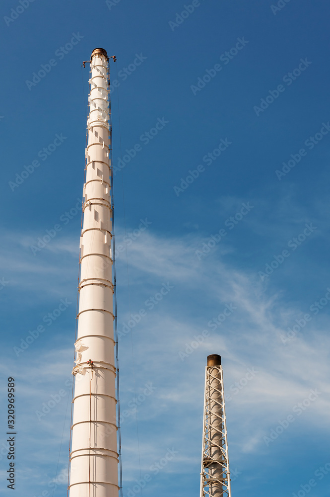 Chimney of chemical factory with blue sky background