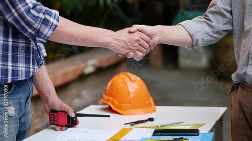 Two engineer shaking hands with contractor after success project construction, handshake.