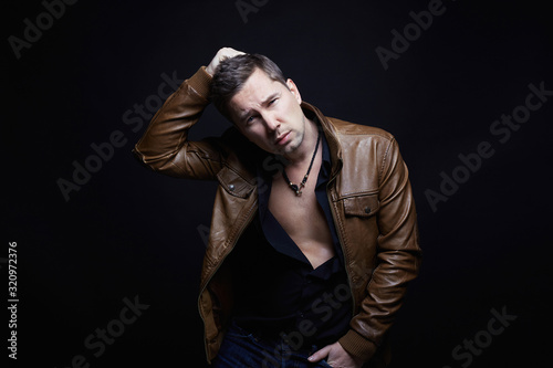 Fashionable young Man in leather coat