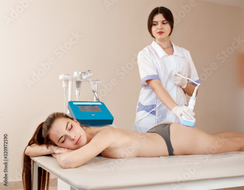 Hardware cosmetology. Body care. Spa treatment. Ultrasound cavitation body contouring treatment. Woman getting anti-cellulite and anti-fat therapy in beauty salon.