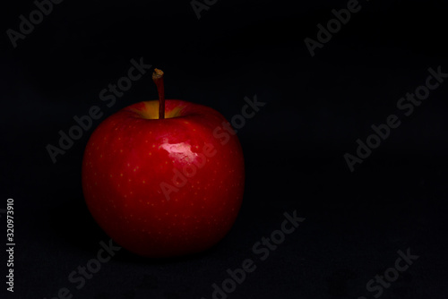 red apple on black background